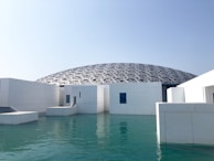white concrete building near body of water during daytime