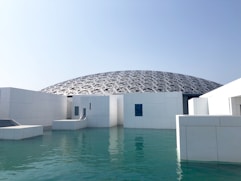 white concrete building near body of water during daytime