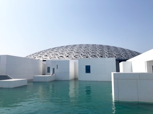 white concrete building near body of water during daytime