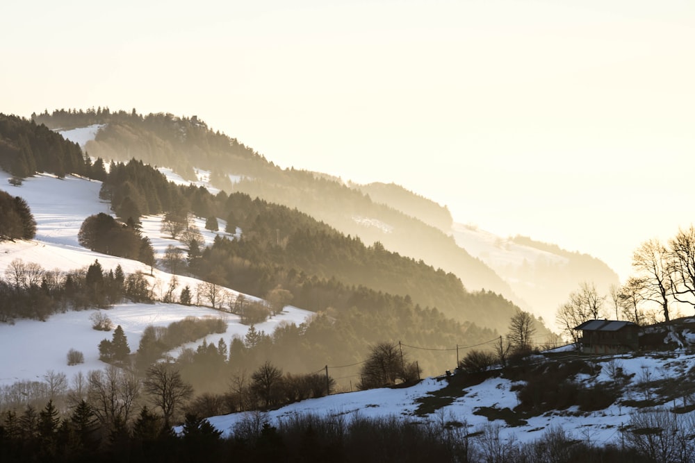 a snowy mountain with a house on top of it