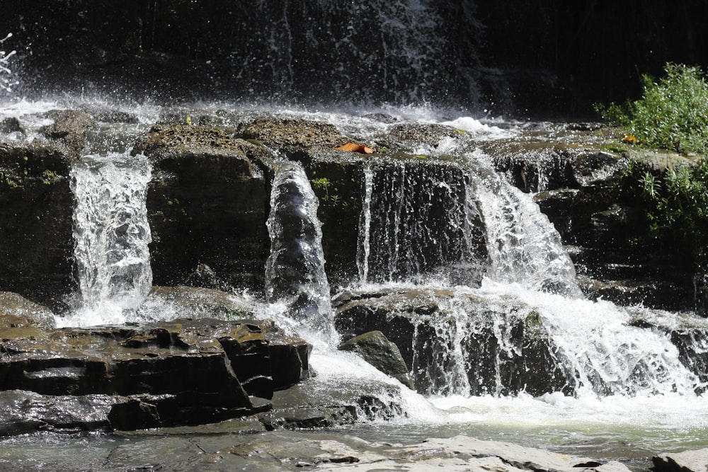 water falls on brown rock