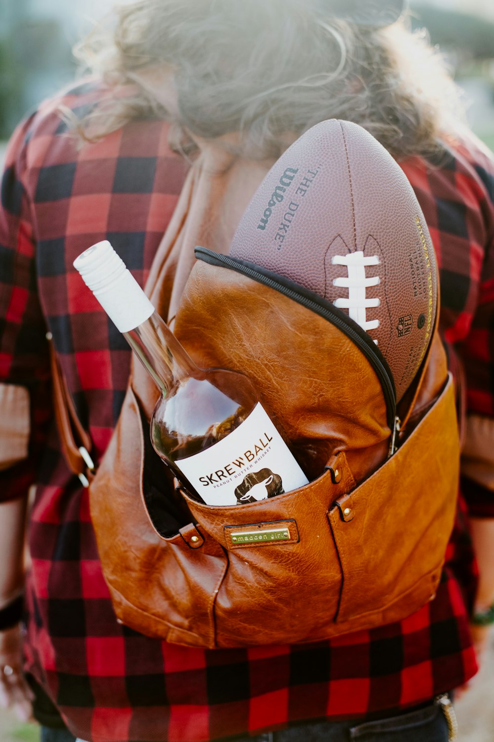 brown leather bag with white plastic fork