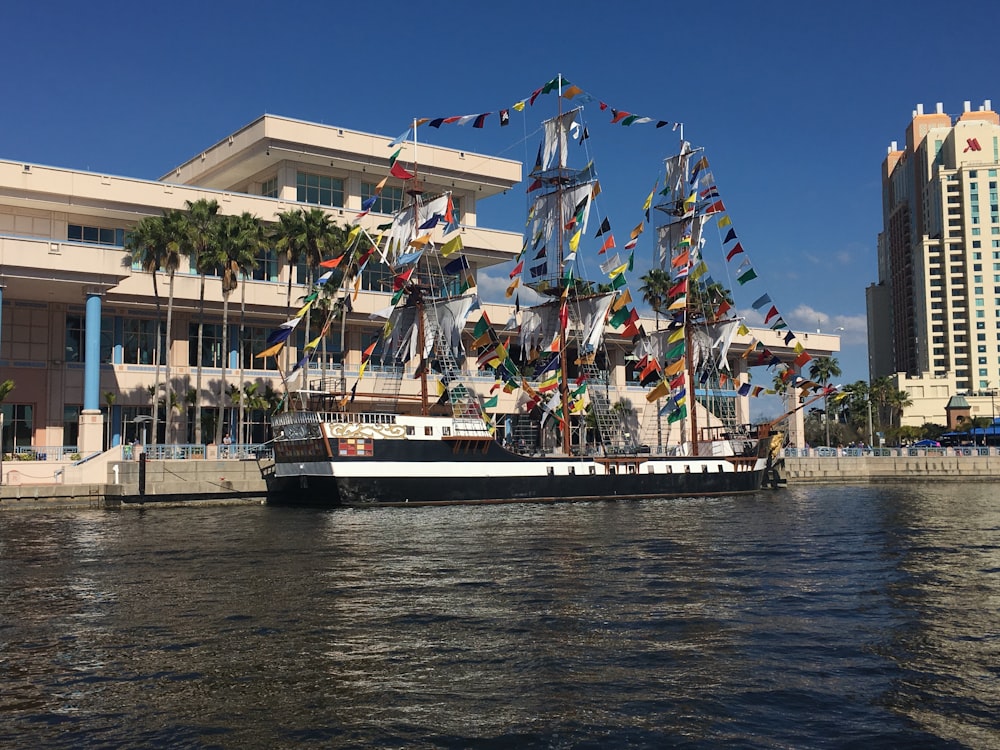 people riding on white and black boat on water during daytime