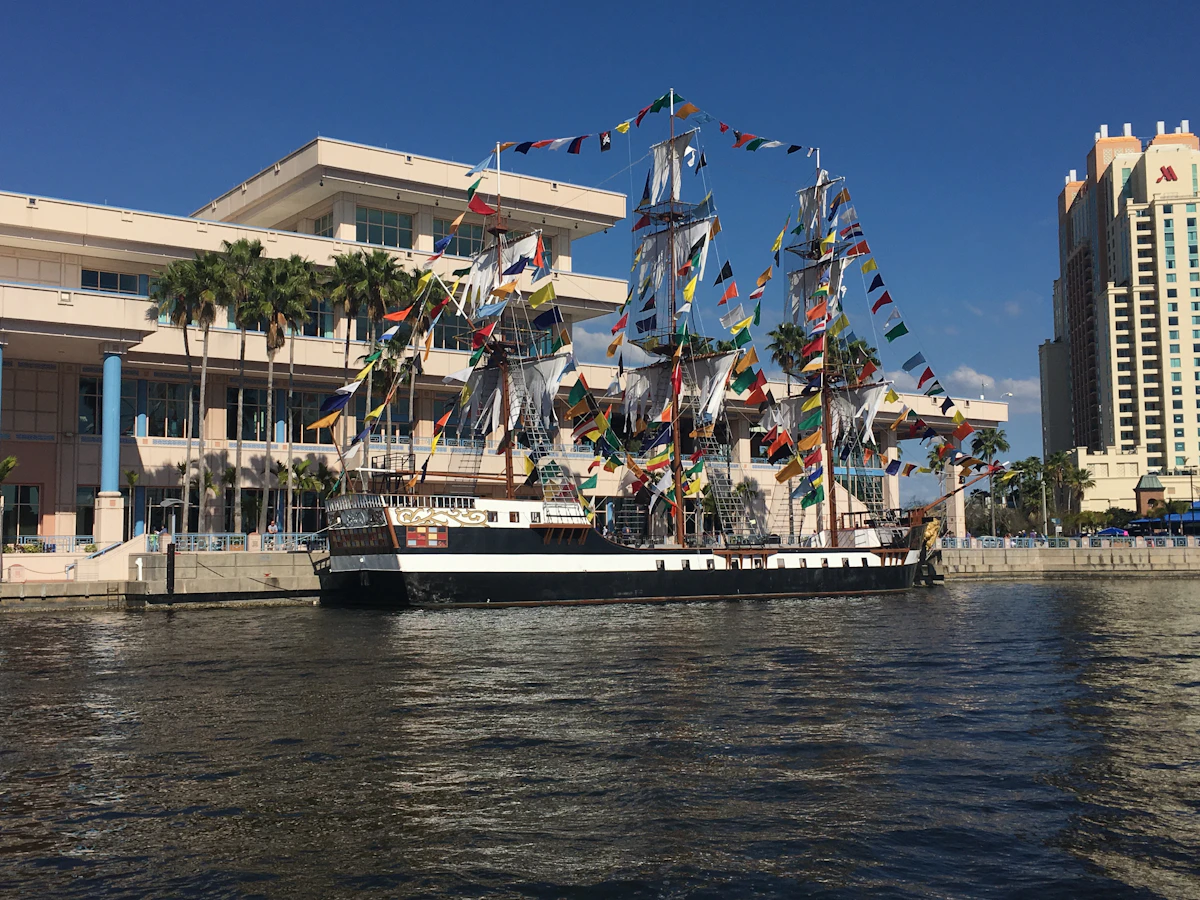 A cruise ship berthed at a Florida port under a clear sky