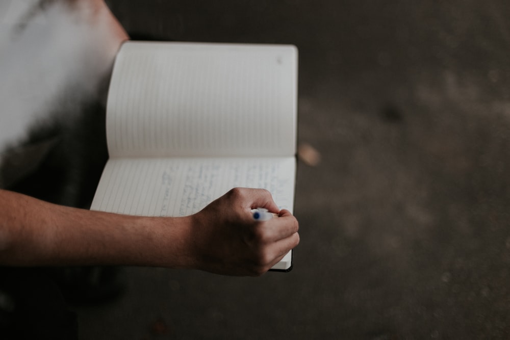 person holding white printer paper