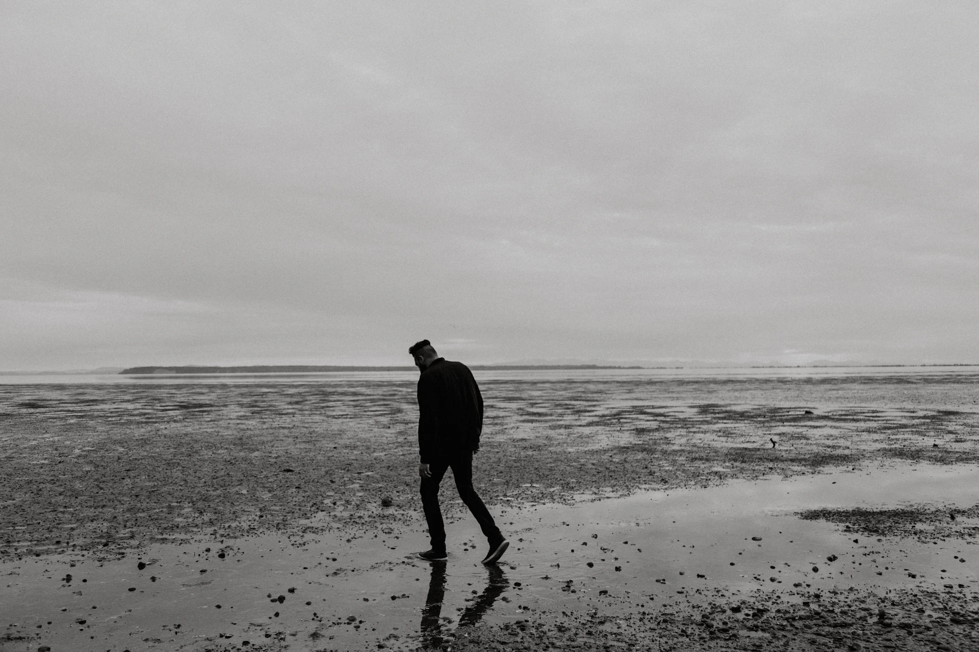 man walking on beach during daytime