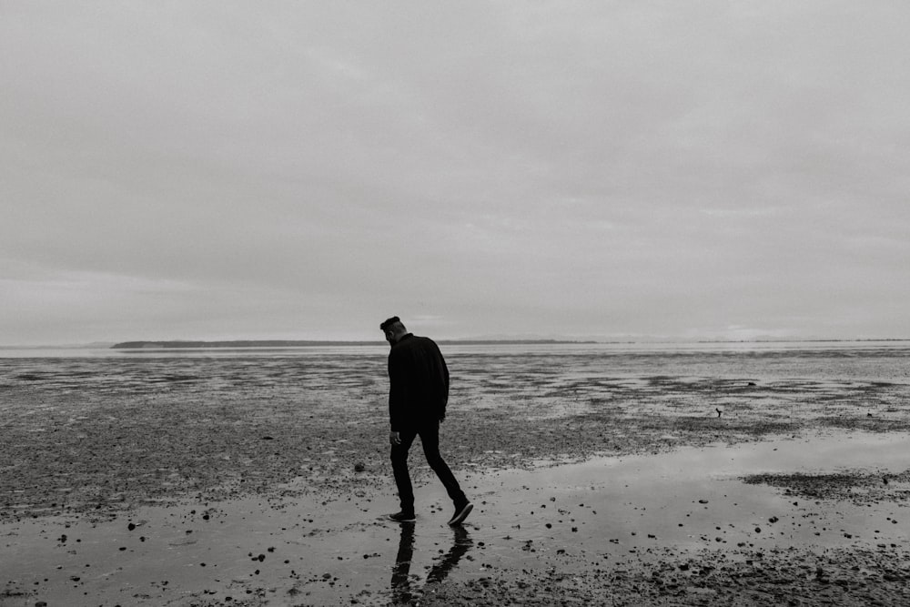man walking on beach during daytime