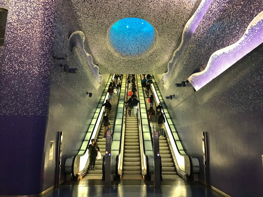 black and gray escalator with blue ball