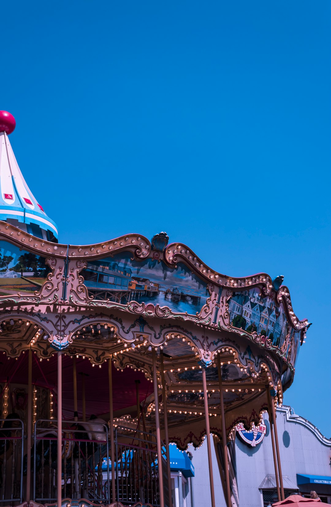 white and red carousel under blue sky during daytime