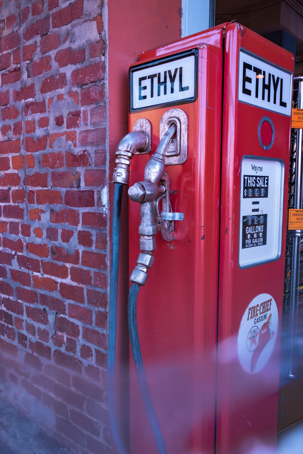 red fire extinguisher mounted on red wall