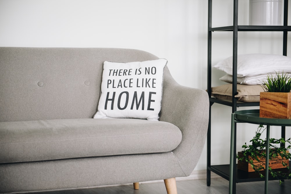 white throw pillow on gray sofa