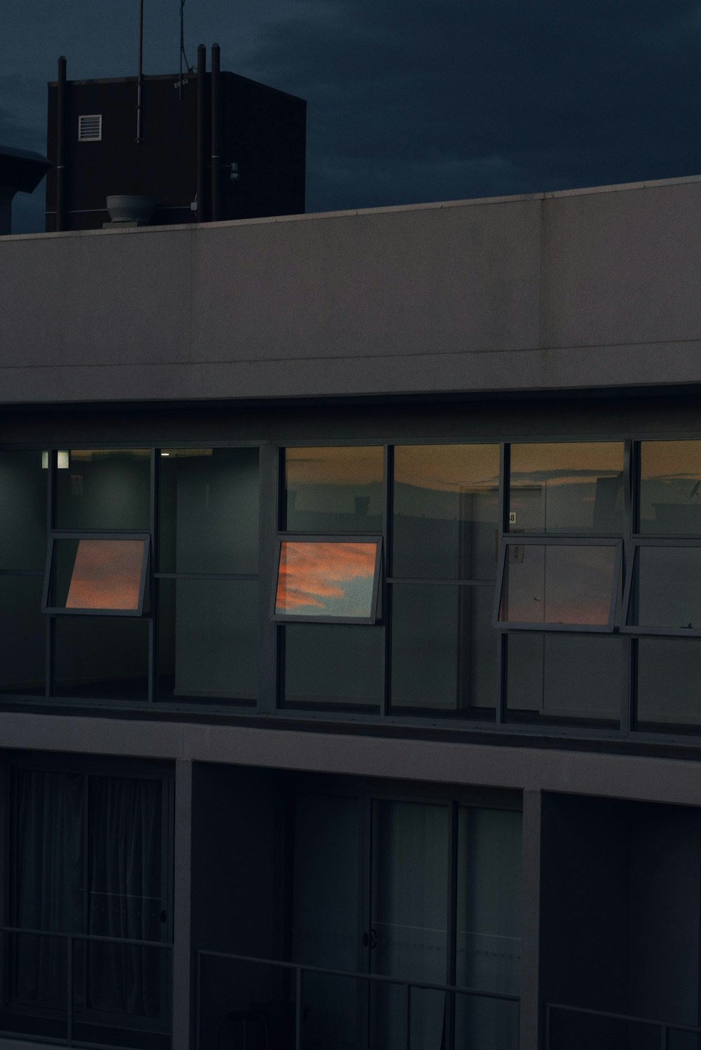 black framed glass window on gray concrete building