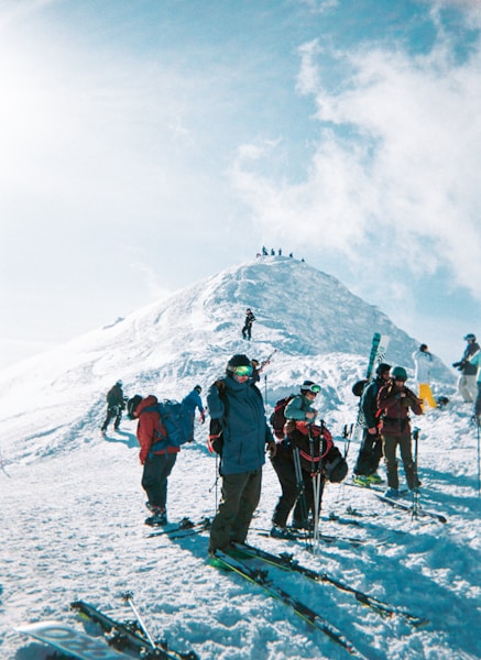 Backcountry skier ascending a snowy mountain with touring gear