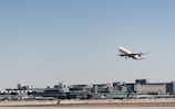 Close-up of a cargo plane taking off with clear blue sky.