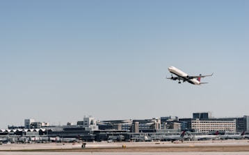 A modern cargo airplane taking off with a blue sky background