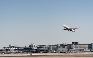 An airplane taking off with a clear blue sky background.