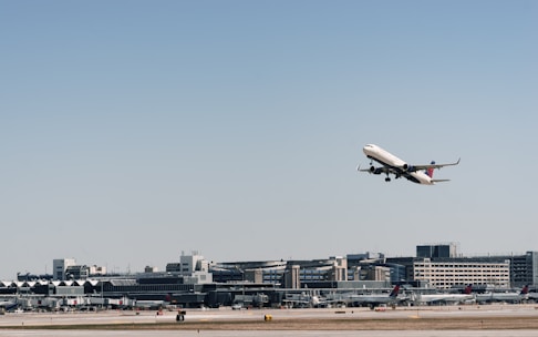 Cargo airplane taking off at sunrise with a clear sky background.