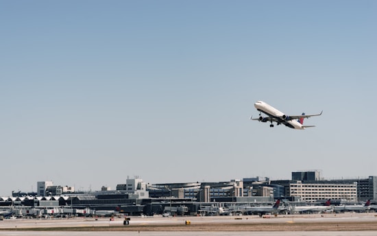 An airplane taking off with a clear blue sky in the background, symbolizing global reach.