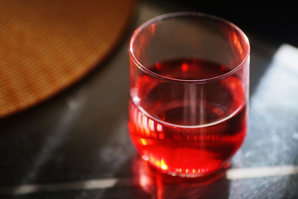 red liquid in clear drinking glass