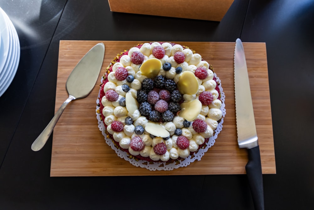 strawberry and blueberry pie on brown wooden table