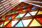 Brightly colored stained glass panels displayed in natural light.