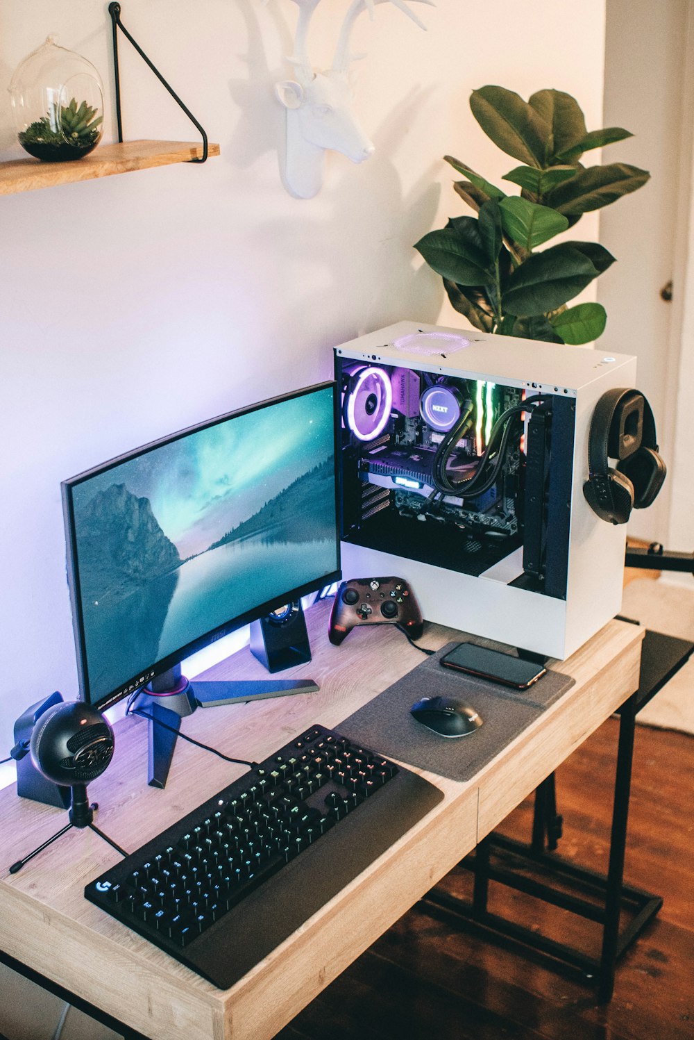 black flat screen computer monitor beside black computer keyboard on brown wooden desk