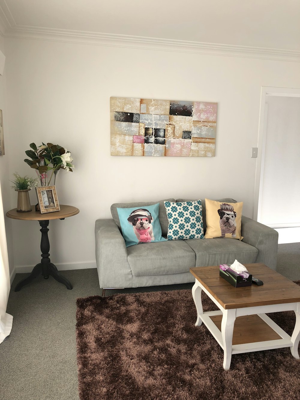 brown wooden table near gray sofa