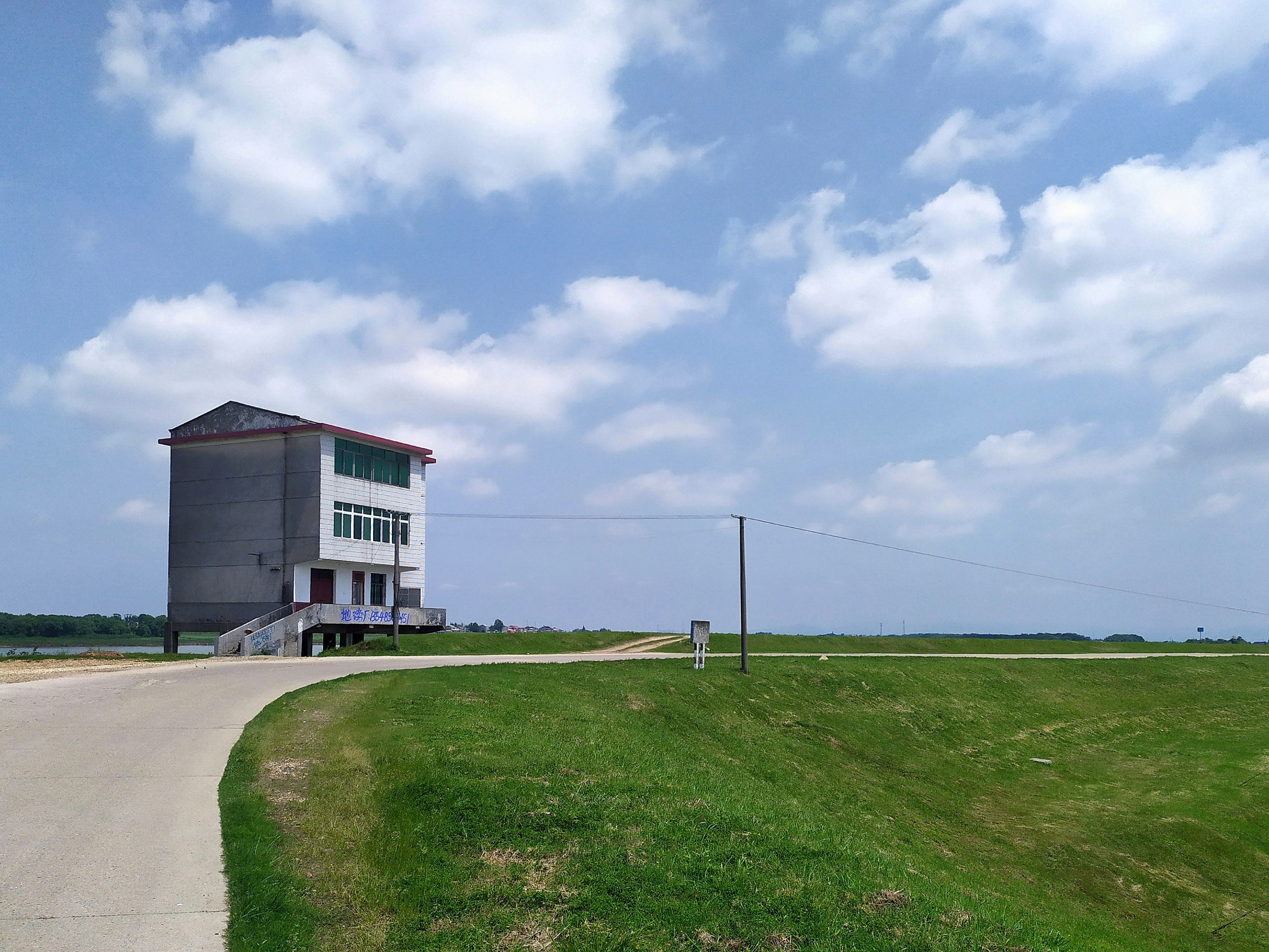 white and brown concrete building under white clouds during daytime