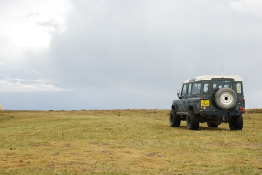 A rugged off-road vehicle equipped with antennas and a Raspberry Pi setup under a cloudy sky.