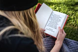 A quiet moment of reflection as a man reads scripture outdoors