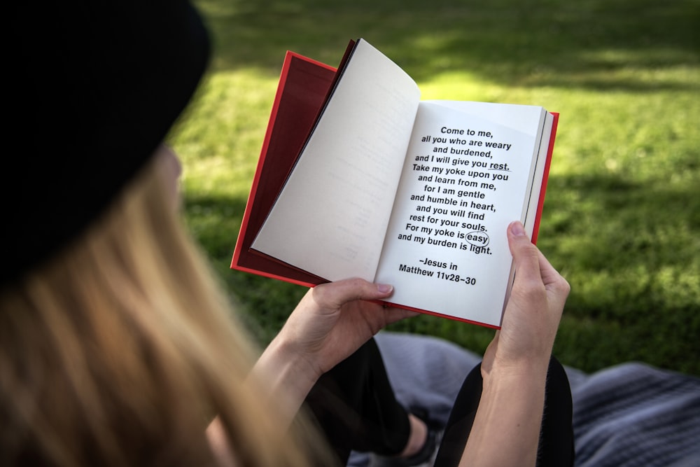 person holding white book page