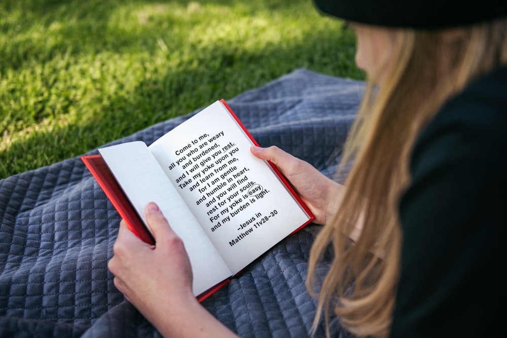 woman in gray long sleeve shirt reading book