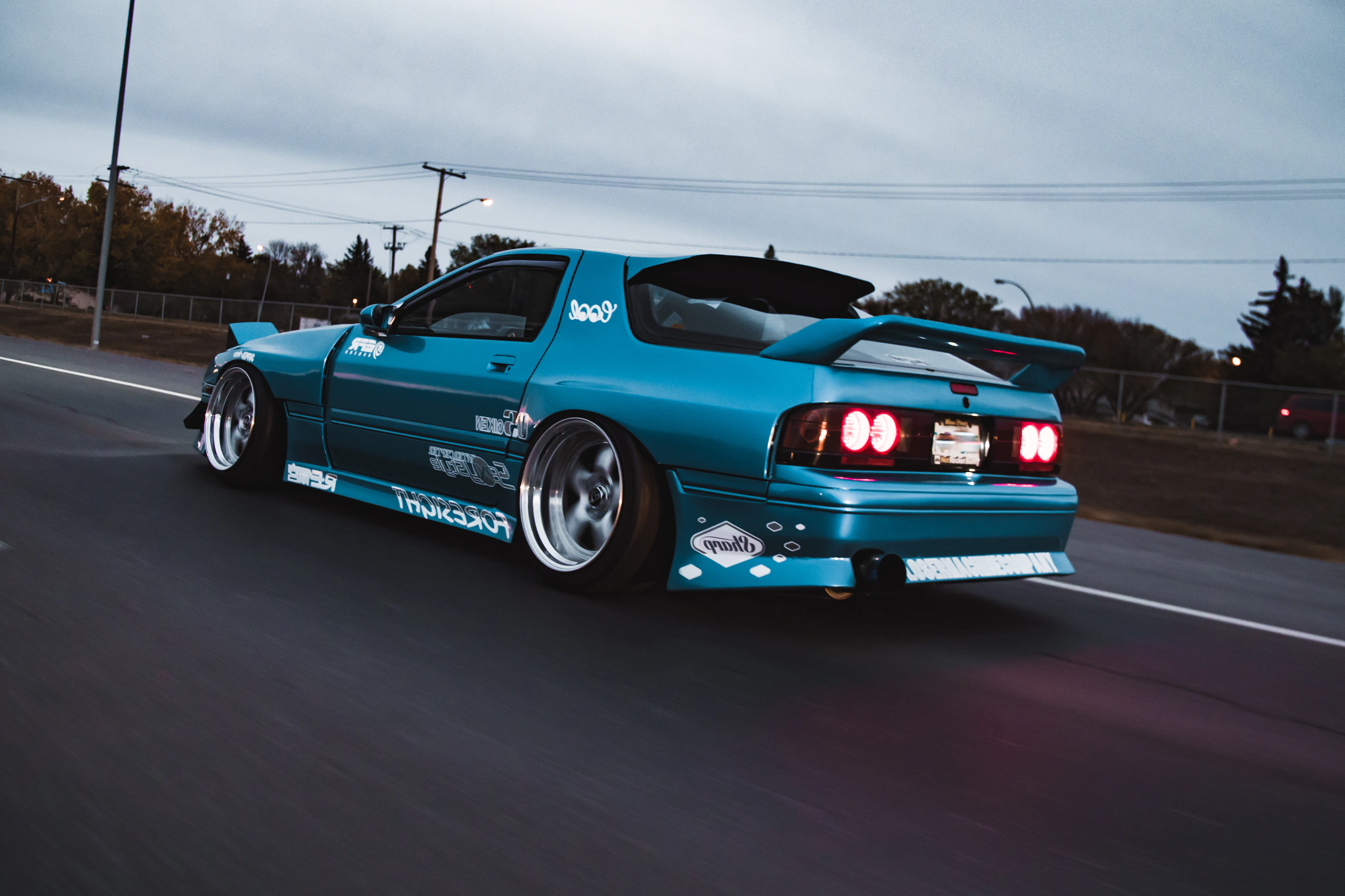 Teal Mazda RX-7 FD on the road at dusk