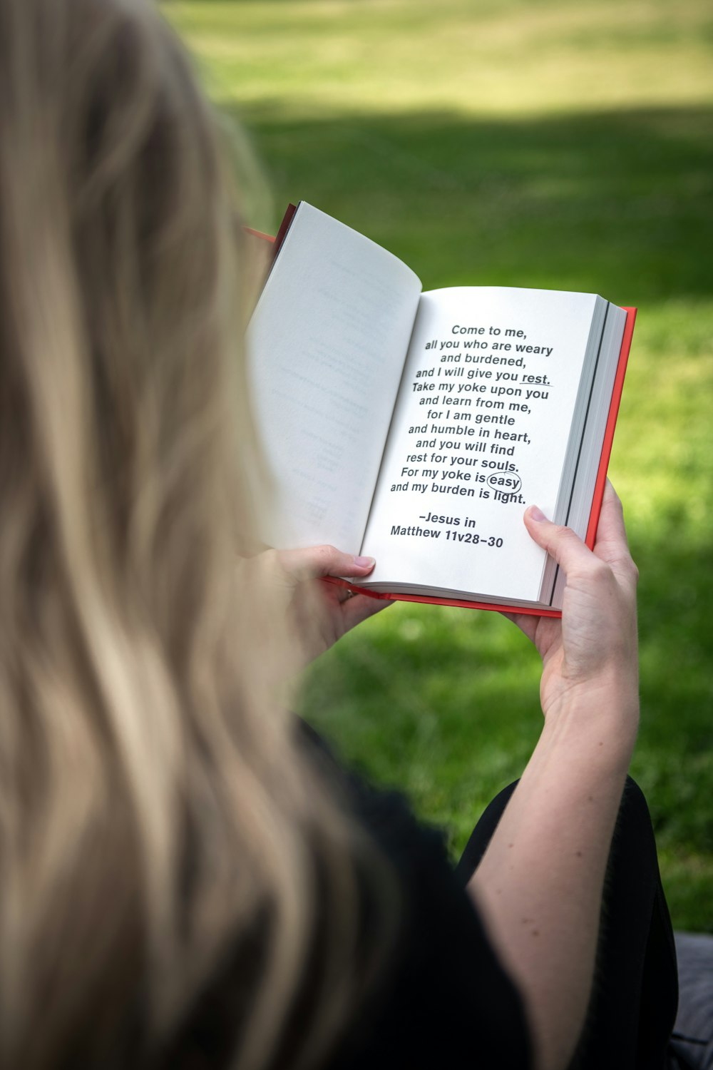 person holding white book page during daytime