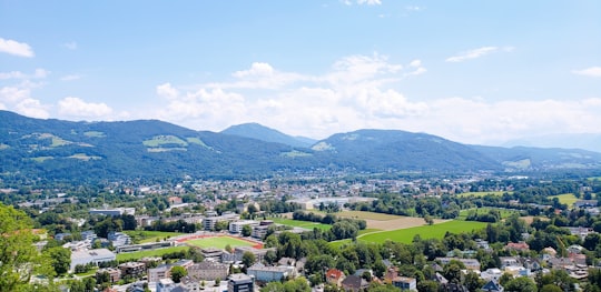green mountains under blue sky during daytime in Hohensalzburg Castle Austria
