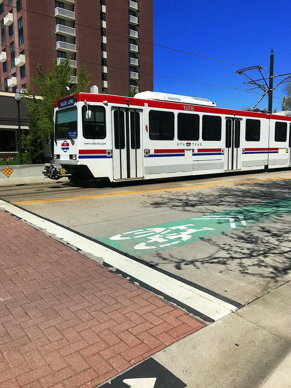 red and white train on track during daytime