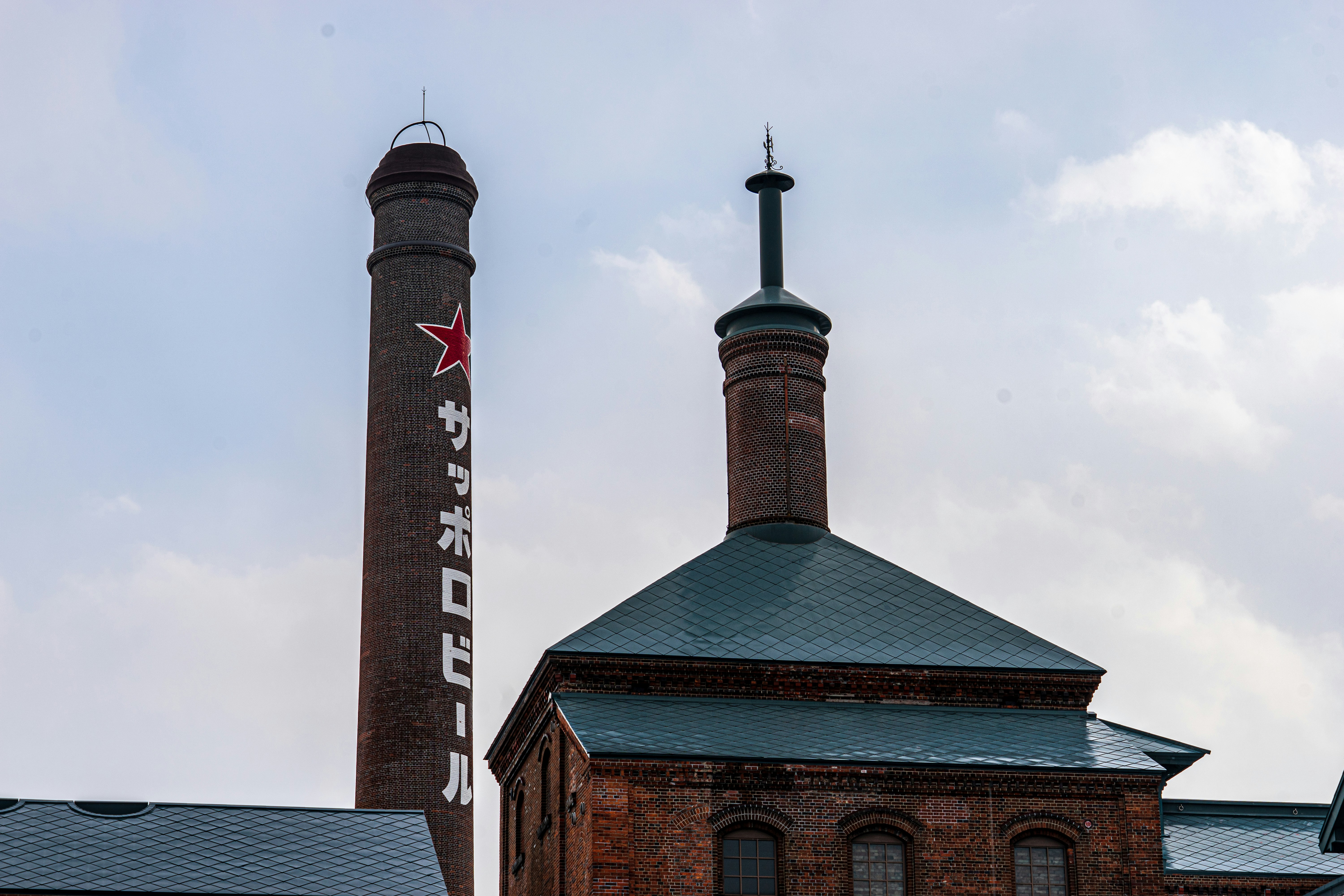 brown and gray concrete building under white clouds during daytime