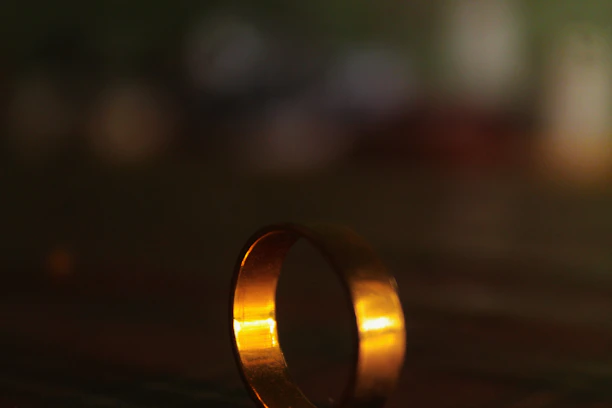 A warm, golden-hued photo of a customer smiling while wearing auksinė aura's elegant ring.