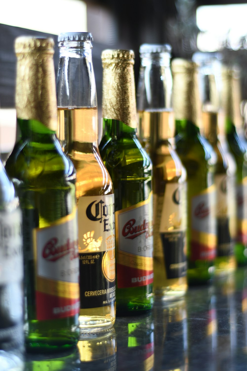 green glass bottles on brown wooden table