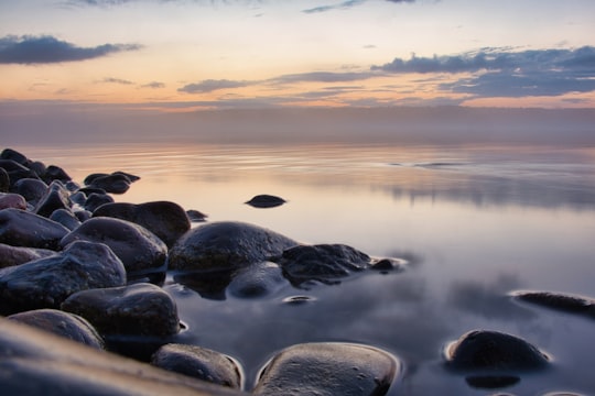 black rocks on body of water during sunset in Krasnoyarsk Russia