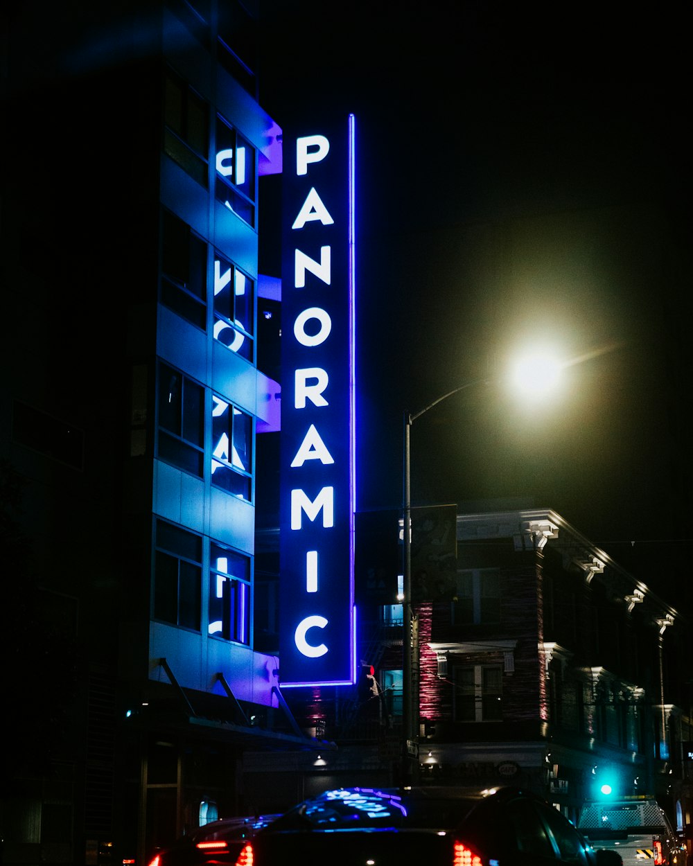 a large neon sign on the side of a building