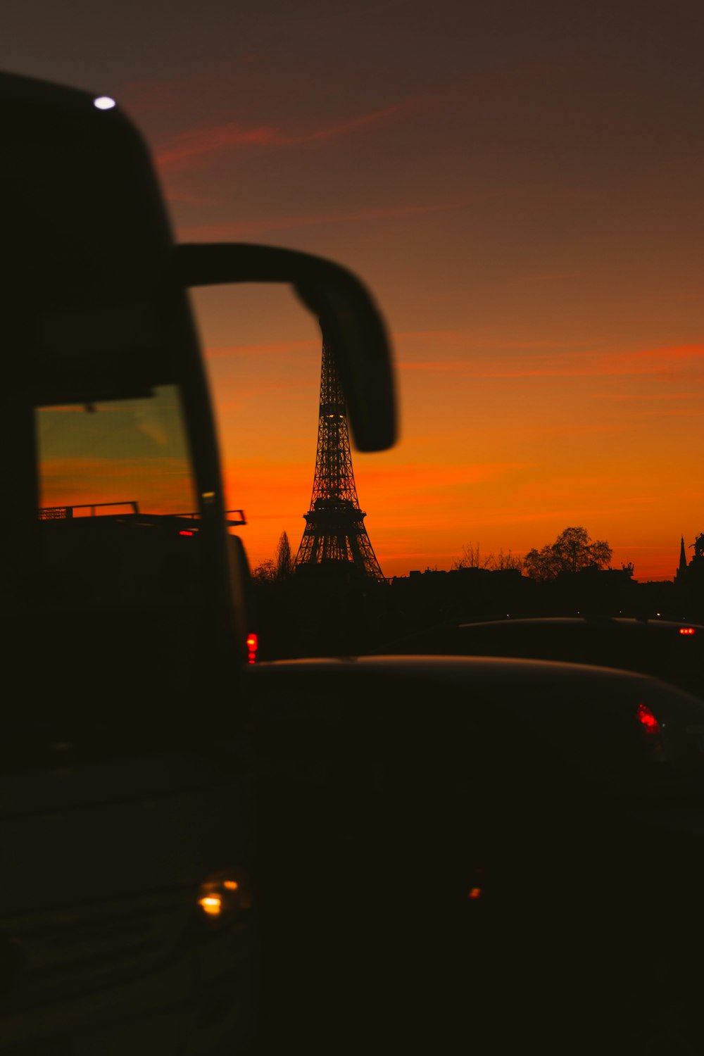 silhouette of trees and buildings during sunset