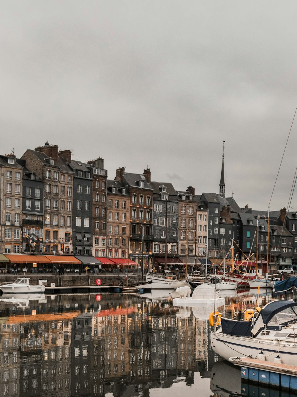 brown and white concrete buildings near body of water during daytime