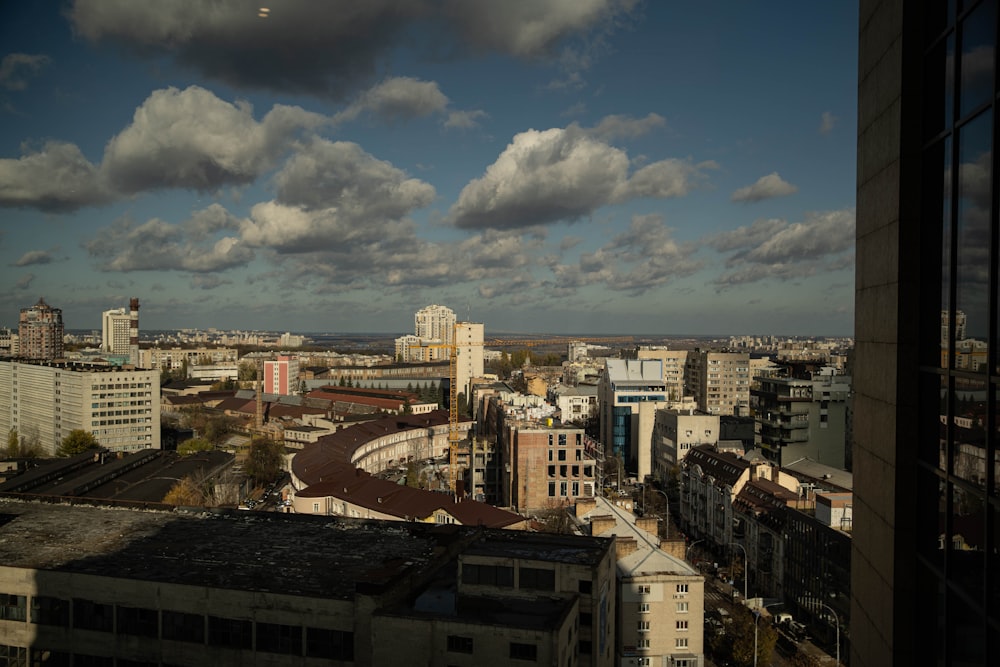 city buildings under blue sky and white clouds during daytime