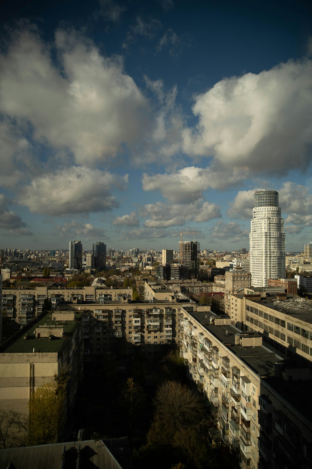 city buildings under white clouds during daytime