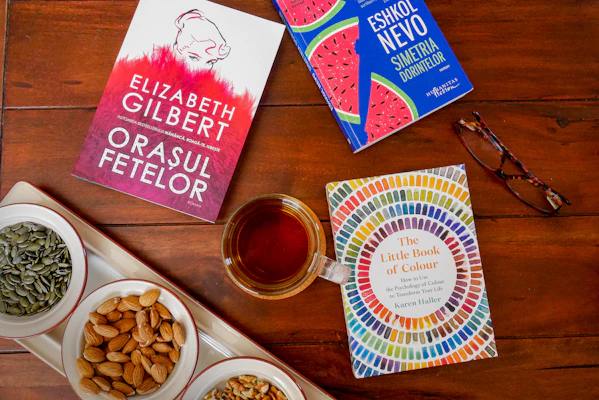 A serene flat lay of wellness ebooks and digital guides on a wooden desk with a cup of herbal tea.