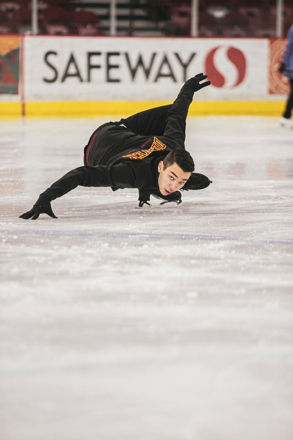 a man is skating on an ice rink