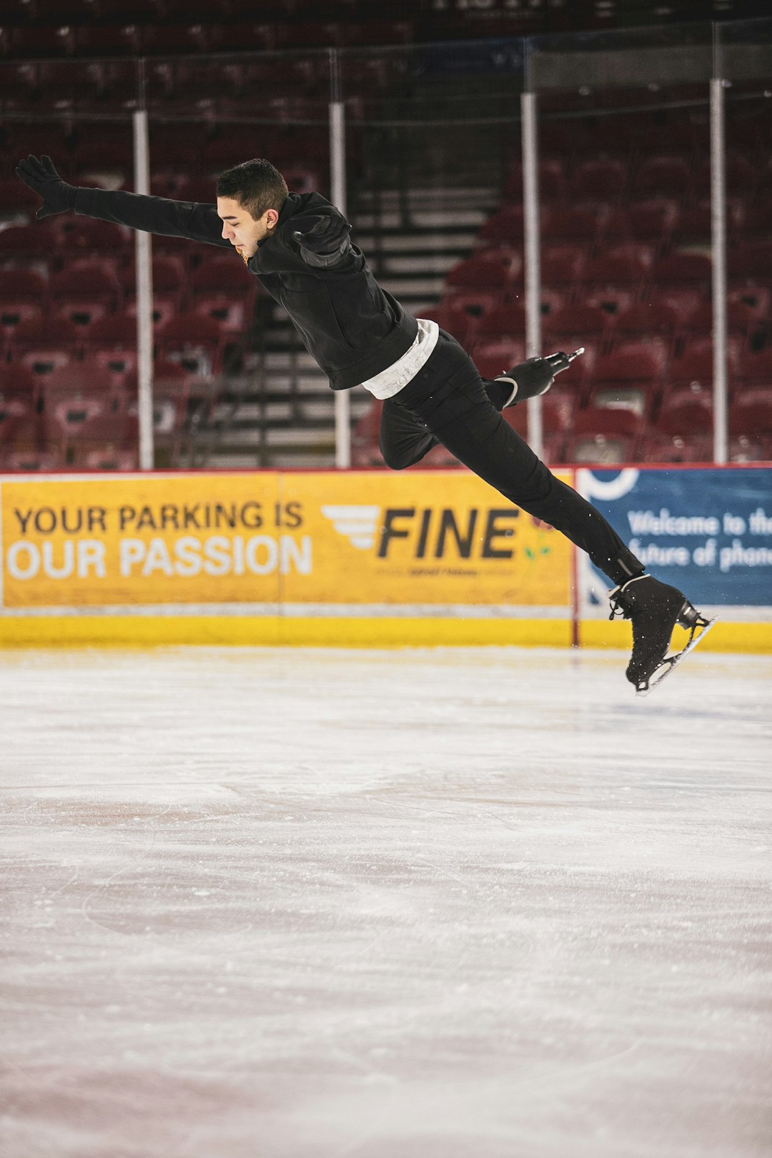 man in black pants and black nike shoes playing ice hockey