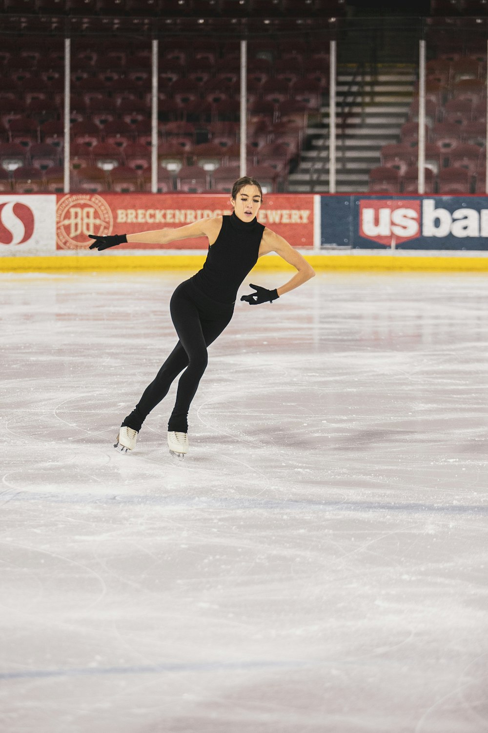 woman in black tank top and black pants playing ice hockey