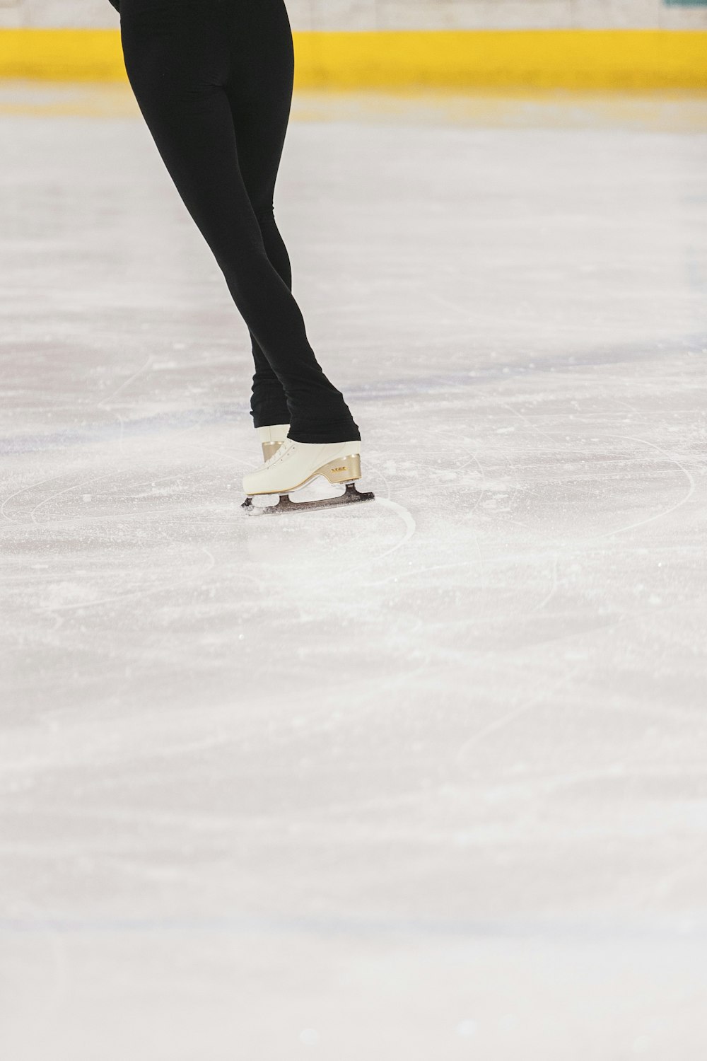 person in black pants and white sneakers